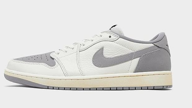 Side view of white and grey Air Jordan sneakers.